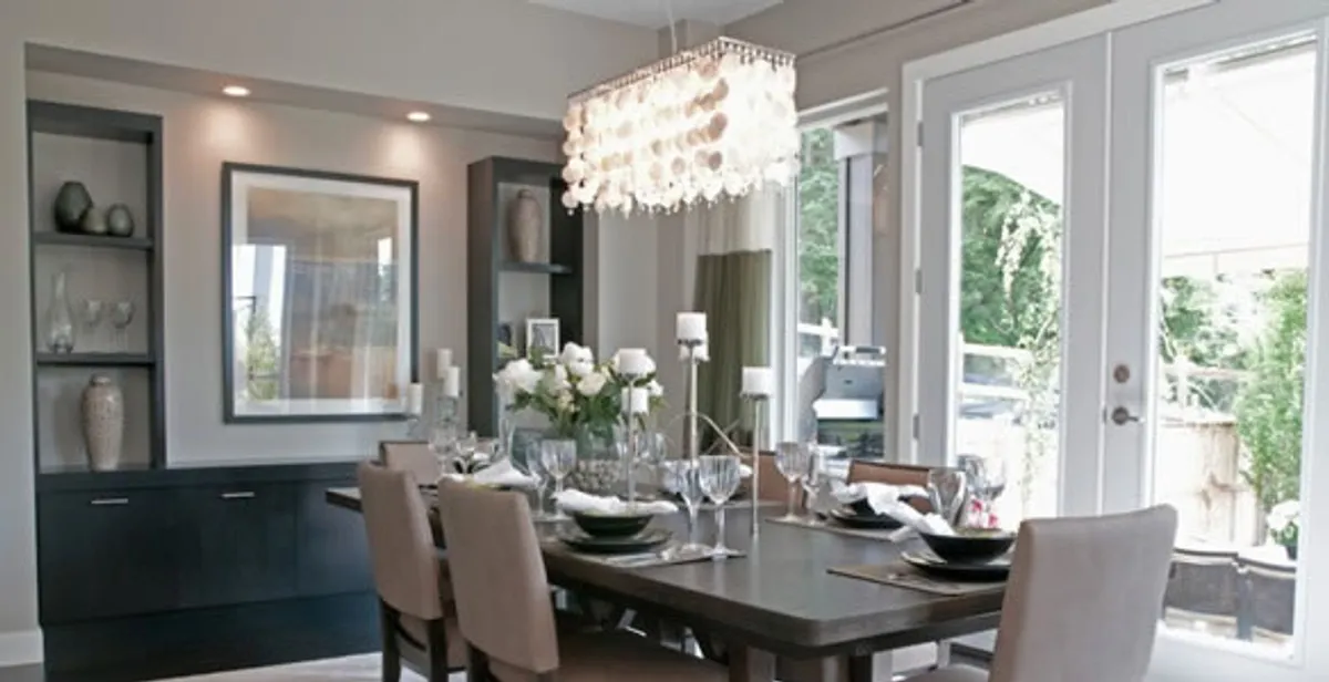 Elegant dining room chandelier installation above table in Dallas, TX