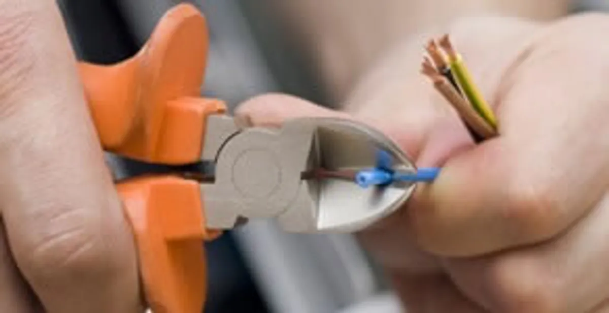 professional electrical services showing precise wire cutting by licensed electricians in Dallas, TX
