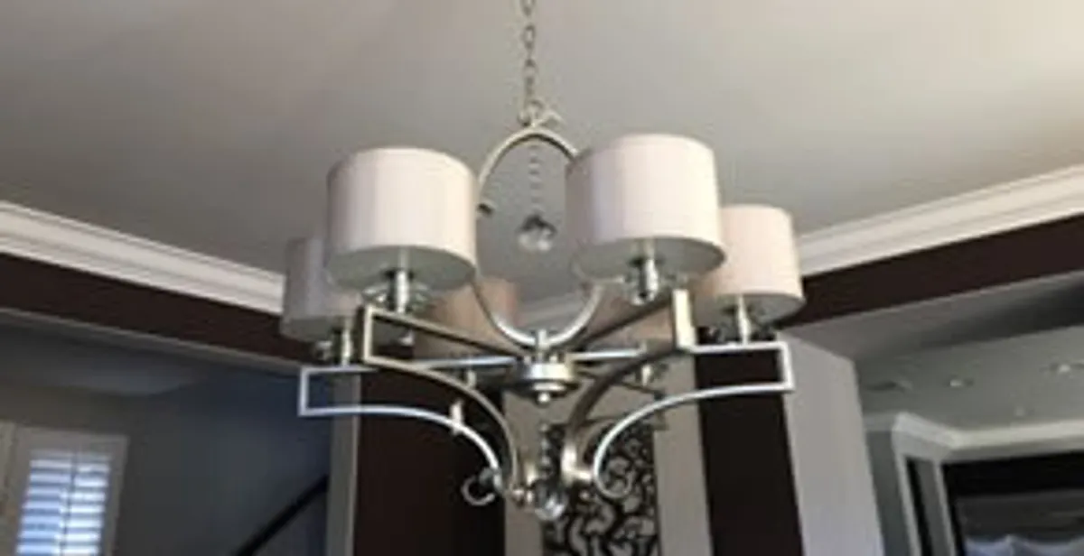 Modern chandelier installation with multiple light fixtures in Dallas, TX